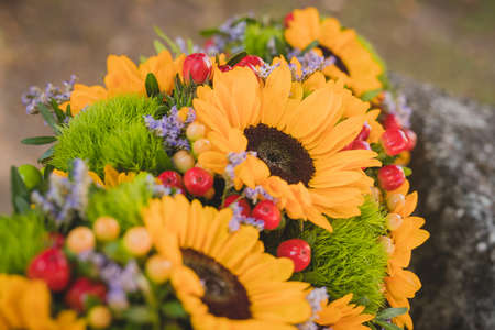 Vintage wedding bouquet of dry flowers,grass, cherries and sunflowers. Vintage wedding bouquet in close detail.の写真素材