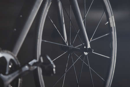 Detail of the front part of a road bicycle on a silky black background.の写真素材