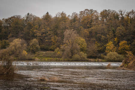 A small water dam in the autumn, close to Otocec castle on Krka river, Slovenaの写真素材