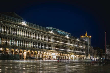 Olivetti exhibition centre on piazza San Marco in Venice, Italy during a rainy night time, with reflections on the floor.の写真素材