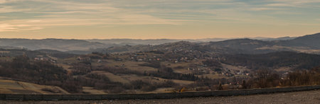 Houses and villages in the polish part of Beskidy or Beskides mountains in early morning during dry winter season.の写真素材