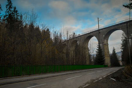 Magical ground view panorama of mystical Glebce viaduct close to Wisla, Poland in late autumn weather. Mysterious train bridge.の写真素材