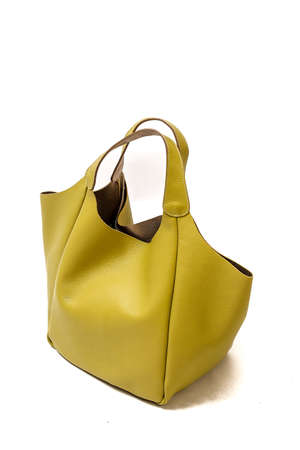 Female handbag in yellow or khaki color, isolated on white.の写真素材