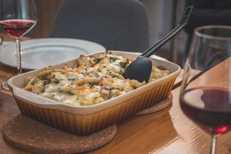 Veggie side dish from cheese, cauliflower and other vegetables served on a wooden table at a celebration.の写真素材