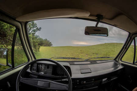 View from the driver perspective of a van parked in nature. Concept of a hippie escape with a van into nature.の写真素材