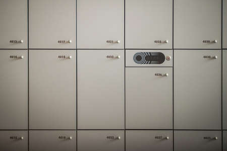 Frontal close up of many lockers or metal or wooden lock boxes. Lockers with numbers, rfid codes and round knobs. visible main part with electrical lock.の写真素材