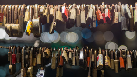 Love bridge with padlocks in Ljubljana on a beautiful night looking towards the three bridges with...