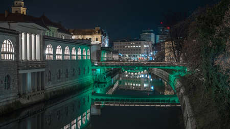 Night panorama of Plecnik arcades in the centre of ljubljana on a beautiful night. Bridges in the background.の写真素材
