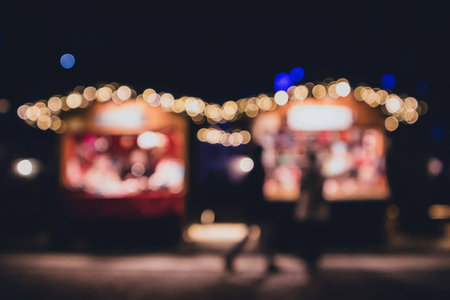 Christmas or new year stalls kiosk out of focus. Two christmas market kiosks out of focus in blur.の写真素材