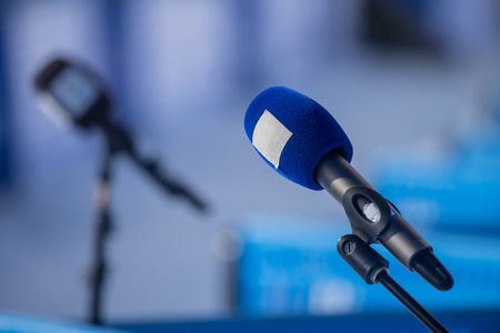 Professional wireless microphone on a microphone stand at a live event or interview area waiting for a person to come by. News radio area on an event.の写真素材