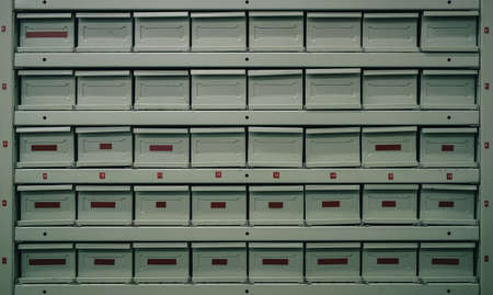 Metal drawers or regals for storing different parts. Fire proof containers at a service or parts warehouse. Side angle view.の写真素材