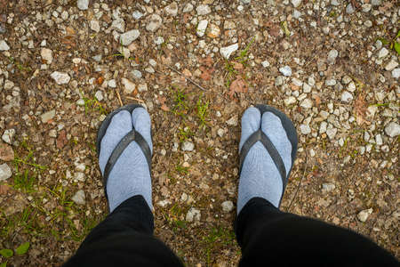 Fashion police victim - wearing sandals over feet covered with gray socks. Terrible thing to do.の写真素材