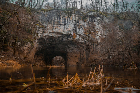 Natural stone bridge or arch in Rakov Skocjan caves and famous landscape in cold autumn setting.の写真素材