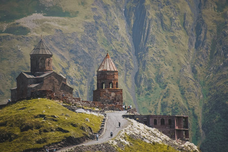 Ancient Gergeti Trinity church Tsminda Sameba, near mount Kazbek, a landmark of Georgia in Caucasus...