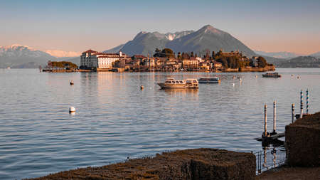 Isola Bella on Lake Maggiore, italy with view of the island and Palazzo Borromeo on a cold winter day. Snowy mountains in the background.の写真素材