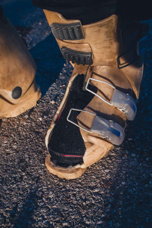 Destroyed old ski boot with a hole inside. Old plastic being ripped apart on a ski boot while skiing, the result of a destroyed ski boot.の写真素材