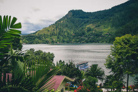 Lake Toba viewed from one of the restaurants in the city of Parapat, northern Sumatra on a cloudy day.の写真素材