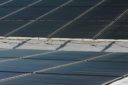 Round tubular solar panels installed on a roof of a building.