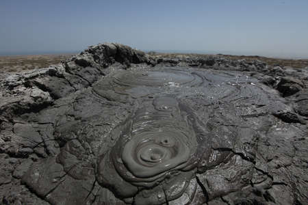 Mud volcano at Gobustan national park in Azerbaijan, close to Baku. Mud is seen boiling in bubbles from the ground, detail of a burst bubble.の写真素材