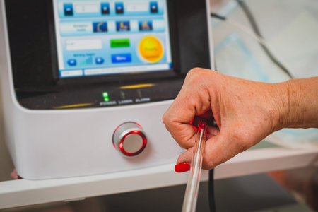 Female doctor is holding a laser used for vaginal treatment of incontinence, Visible ray of laser...