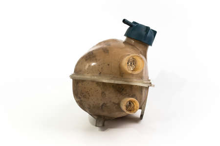 Old and worn rounded car coolant expansion tank on a white background, isolated on white. Worn automotive parts in dirty condition. Front viewの写真素材