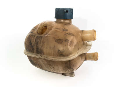 Old and worn rounded car coolant expansion tank on a white background, isolated on white. Worn automotive parts in dirty condition. Side viewの写真素材