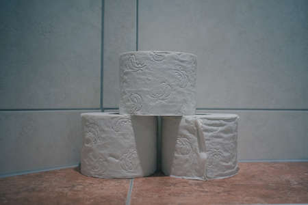Three toilet paper rolls on a marble or granite background in a hotel bathroom.の写真素材