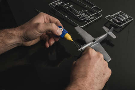 Detail of assembly of plastic model aeroplane resin kit with glue. Cement glue used to glue parts of plastic model aeroplane together.の写真素材