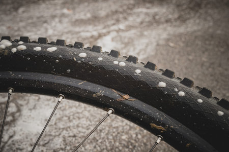 Perforated or punctured mountain bicycle tire, with visible foam escaping through perforated holes....