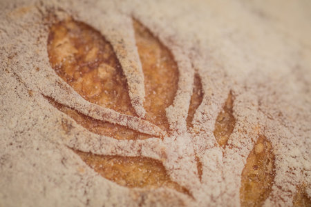 Home made traditional loaf of bread in slovenia with detail of carved images of leaves and grain...