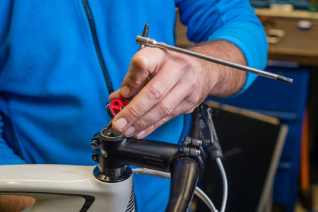 Inserting a star nut in a stem to tighten and eliminate play in headset bearing on a bicycle....