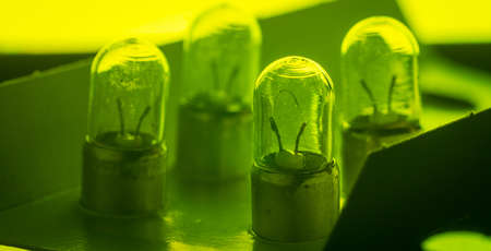 Detail of older type position lamp bulb of a car. Multitude of position lightbulbs in a bulk cardboard packaging.の写真素材