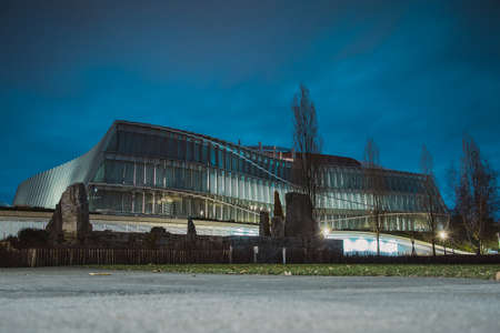 Building of ComitÃ© International Olympique or Olympic comitee in Lausanne, Switzerland, at night. Cloudy night above the olympic building.のeditorial素材