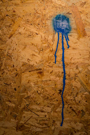 Dirty OSB wood board. OSB panel board with a splat of red paint on it. Concept to write sometnhing on plateの写真素材