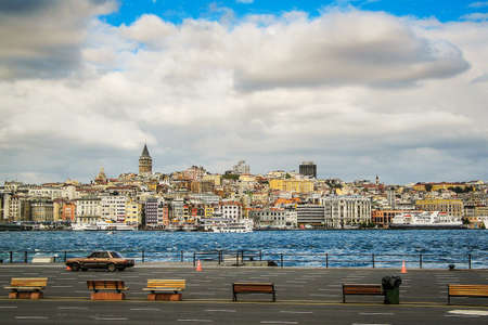 View towards Beyoglu and Karakoy in the city of Istanbul over the sea just next to the Galata brdge. Famous Galata tower or Galata Kulesi is rising above the skyline.の写真素材