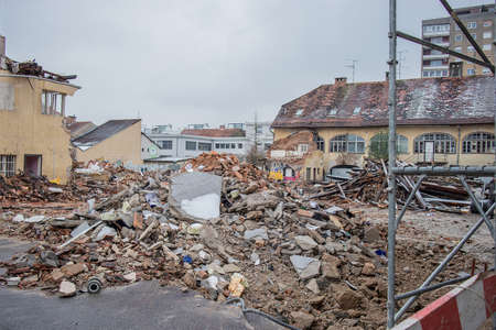 Demolition of old houses in an urban aerea. Destruction or demolishing old house to make way for a new house in a city neighbourhood on a cold day.のeditorial素材