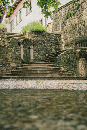 View towards the vintage stairs or staircase made of rock and marble on a terrace in the village of Stanjel, Slovenia on a romantic rainy dayの写真素材