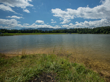 Panorama of Zovnesko jezero or Zovnek lake in Slovenia, on a hot summer day. Visible man made dam in the background used for irrigation.の写真素材