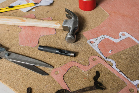 Making a new paper gasket for hobby  automotive program. Visible centre punch, scissors, material...