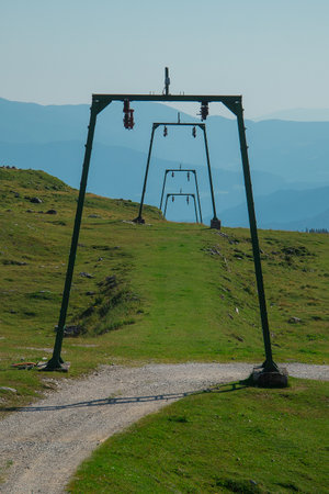 Abandoned older style ski lift on Velika Planina, Slovenia on a sunny summer day.の写真素材