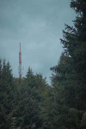 Big antenna mast for 3G, 4G and 5G repeater in the middle of the forest or nature. Controversial tehnology in the wild nature. Panoramic view.の写真素材