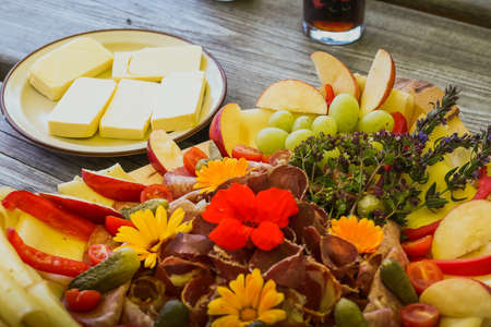Cheese and fruit assortment on a plate or on a table.の写真素材