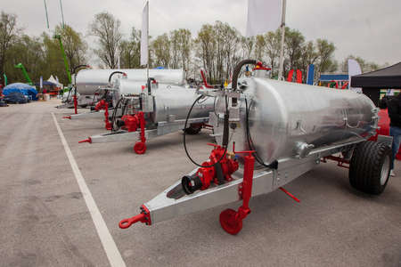 Scene from a farm business fair, showing a collection of manure tankers in stainless steel color.の写真素材