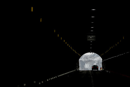 The Grossglockner - Hochalpenstrasse, a famous alpine road in Austria, a picture of Hochtor tunnel with a silhouette of a car.の写真素材