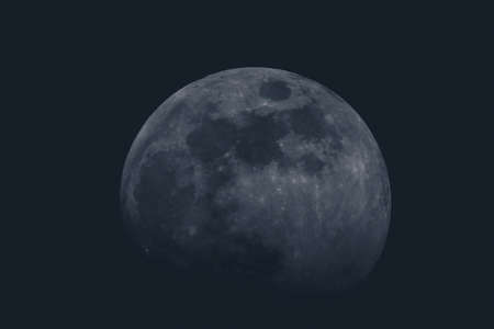 Full moon over dark background sky. Closeup of a moon on the sky, with slight fade to black on the bottom. Round shape of a moon on black sky.の写真素材
