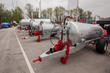 Scene from a farm business fair, showing a collection of manure tankers in stainless steel color.の写真素材