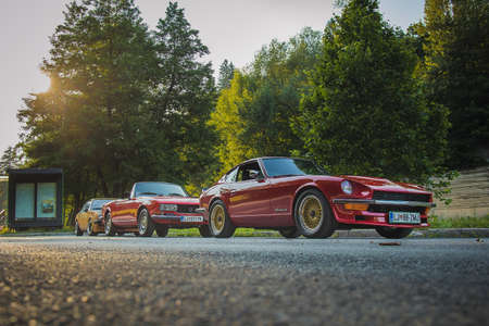 Ljubljana, Slovenia, 25.6.2019: A group of old vintage cars, including Datsun 240Z, Opel Manta B, Peugeot 504 and Bmw E21 325 and 2002 tii, waiting to start the ride.のeditorial素材