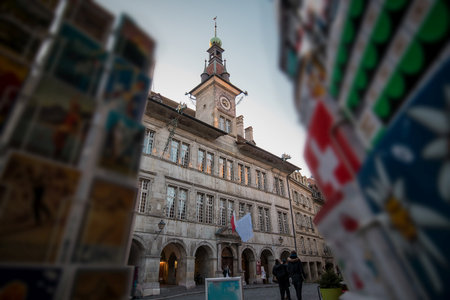 Lausanne City hall with clock tower in early afternoon, looking through the swiss vintage postcards in the foreground.のeditorial素材