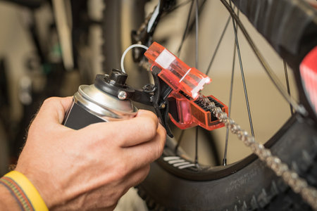 Cleaning of bicycle chain using a dedicated tool for cleaning. Plastic container with rotating brushes for cleaning the chain in opened state.の写真素材