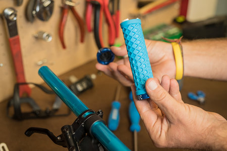 Lock on bicycle grips waiting to be installed on handlebars. Hands of a person seen holding grips to be installed on a bicycleの写真素材